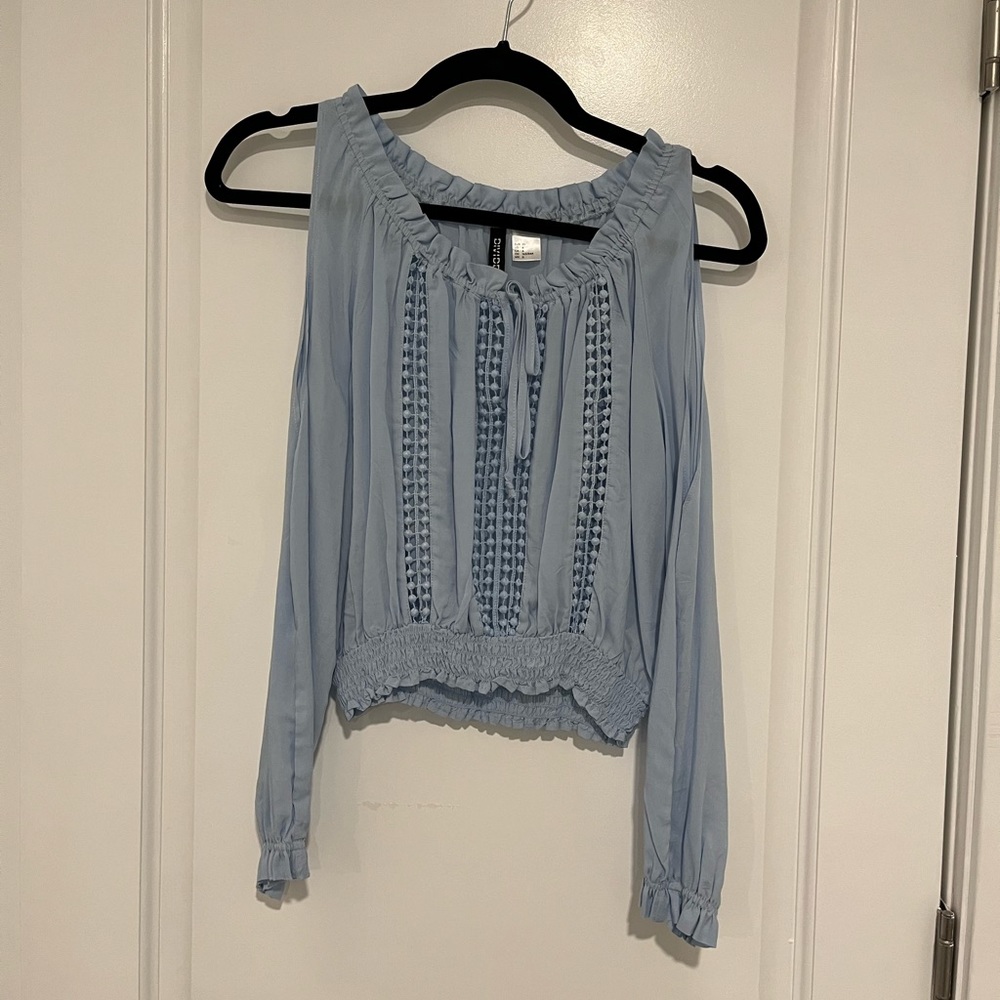 Light blue long sleeve crop top with shoulder cutouts and see through details